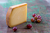 Piece of Comté cheese and grapes