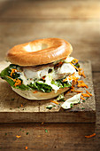 Pollock and white cabbage bagel sandwich