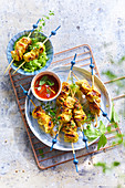 Aperitif chicken skewers with tomato and mint sauce
