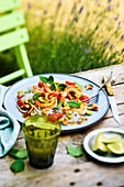 Thai salad with shrimps, rice noodles, tomatoes, basil and cashew nuts