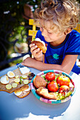 Child eating a Tunisian sandwich