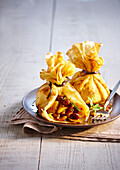 Pancake purses garnished with caramelized apples and dried fruit