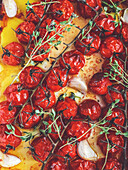 Roasted cherry tomatoes on the vine with garlic and thyme