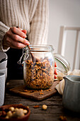 Granola with roasted hazelnuts in a storage jar