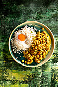 Chickpea curry with cauliflower served with rice and fried egg (Asia)