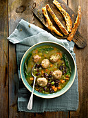 Soup with chicken meatballs, spinach, and kidney beans