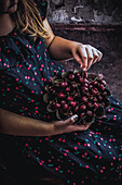 Bowl of cherries in the hands of a child