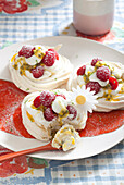 Small pavlovas with passion fruit and raspberries