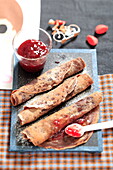 Chocolate crepes with strawberry jam