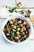 Squid ink tagliatelle with clams, grilled bacon. and parsley
