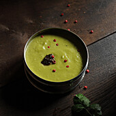 Cream of pea soup with pink peppercorns