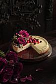 Cheese Cake decorated with red berries and rose petals