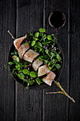 Raw white fish skewer on sprouts