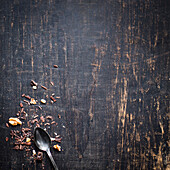Chocolate chips and walnut pieces on a dark wooden background