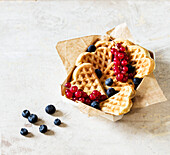 Heart-shaped waffles with fresh berries