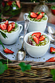 Tiramisu with pistachio and strawberries in cups