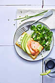 Waffles with smoked salmon and avocado served with lamb's lettuce