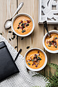 Butternut squash soup with roasted bacon and pumpkin seeds