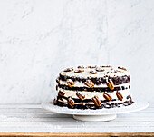 Naked cake with chocolate, cream and nuts