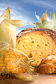 Cornbread, cut in front of a fresh corncob (Close Up)