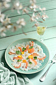 Cod carpaccio with citrus fruit and a glass of white wine
