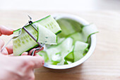 Cutting cucumber strips for Thai beef salad with a vegetable peeler