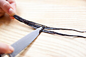 Scrape the vanilla seeds out of the vanilla pod with a knife