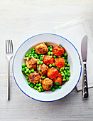 Meatballs with peas and tomatoes