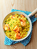 Rice with prawns and peas in a pan