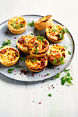 Small quiches with salmon and pink pepper