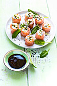 Spring rolls with salmon, spinach shoots, avocado and black sesame