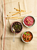 Three dips: olive paste, beet hummus, walnut and red pepper dip