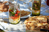Galician empanada, tuna pie with piquillo peppers and rice salad in a jar