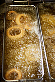 Breaded onion rings prepared in a deep frying basket
