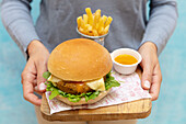 Chicken burger with egg, cheddar cheese and rocket served with fries and mustard sauce