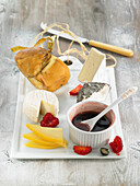 Cheese platter with red fruit coulis