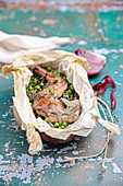 Leg of rabbit with peas in paper (spring dish)