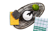 Baking powder, cleaning sponges, lime and a tea towel