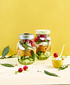 Fermented vegetables layered in screw top jars