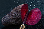 Slicing a beet on a black background
