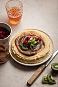 Crêpes with chestnut cream, kiwi and raspberries with a glass of cider