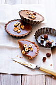 Toffee tartlets topped with roasted hazelnuts
