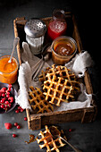 Liège waffles with jam, icing sugar and strawberry juice