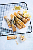 Sardines with lemon, coriander and pine nuts in pastry