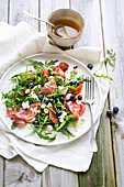 Rocket salad with coppa, blueberries, hazelnuts, pomelos and brousse