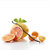 Composition with citrus fruit and vanilla on a white background