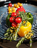 Fresh summer vegetables with herbs on a grill grate