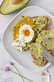 Avocado toast with a soft-boiled egg and chives