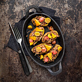 Potatoes garnished with shredded duck and Autumn fruit
