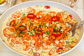 Dish of shrimps with coconut milk on a white tablecloth